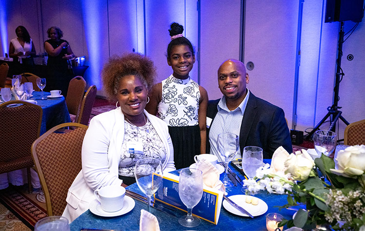 A family at the Alumni Awards Dinner.