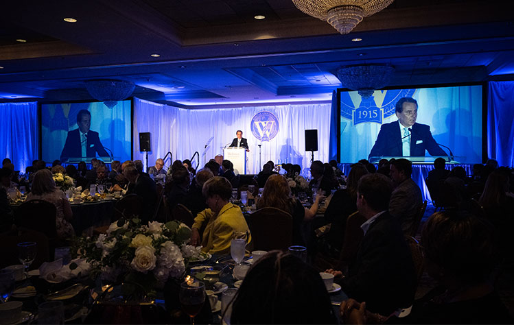 President Julian Z. Schuster speaks at the Alumni Awards Dinner.
