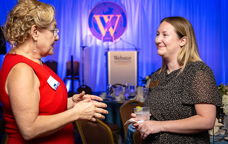 Two Webster employees enjoying conversation at the Alumni Awards Dinner.