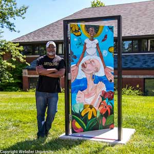 Byron Rogers stands next to the door he painted