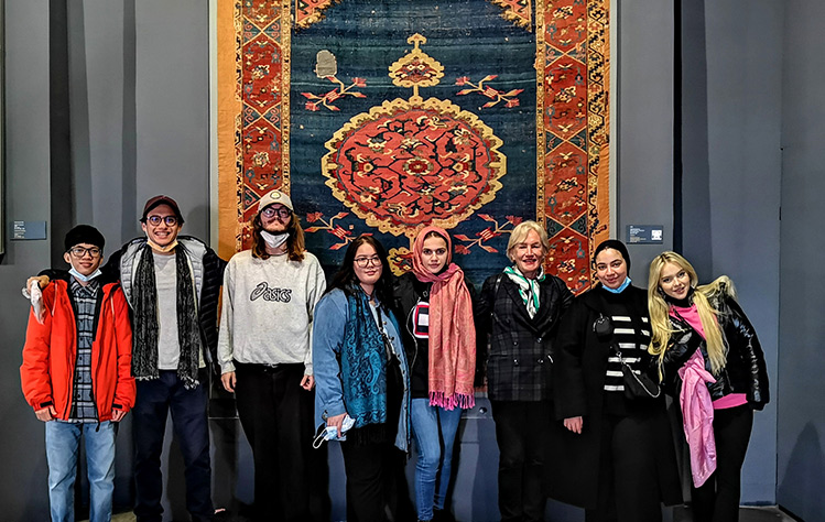 Students in front of a taperstry, visiting art in Istanbul