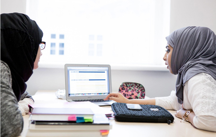 Two students collaborating at a tablet