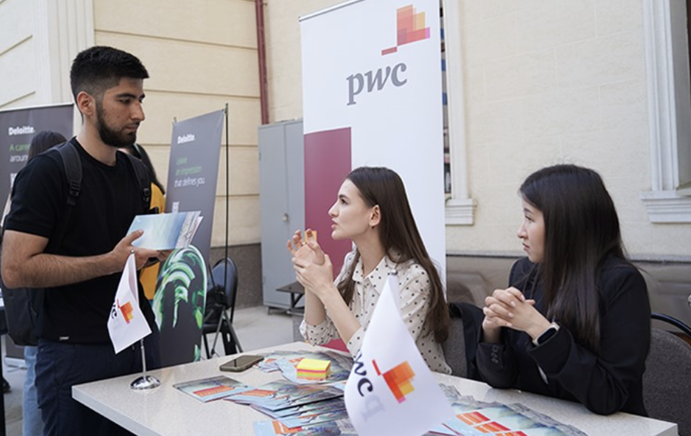 A student speaks with company representatives. 