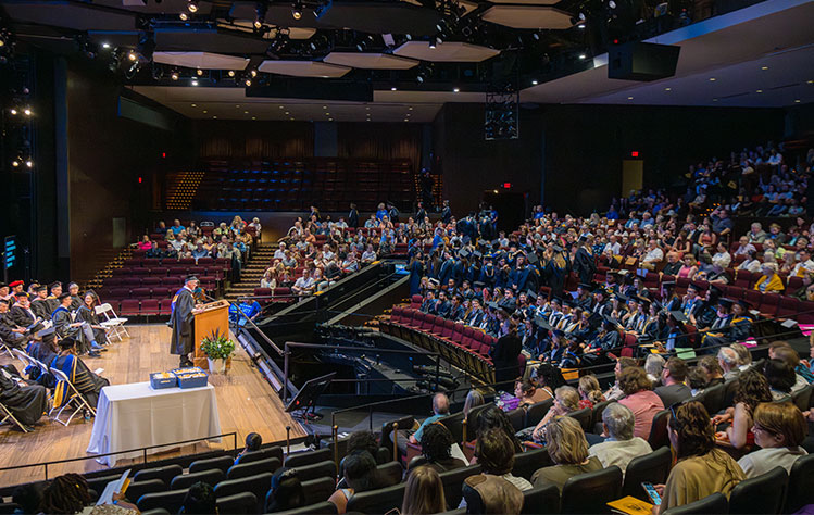 A master's commencement ceremony takes place in the Loretto-Hilton Center Auditorium.