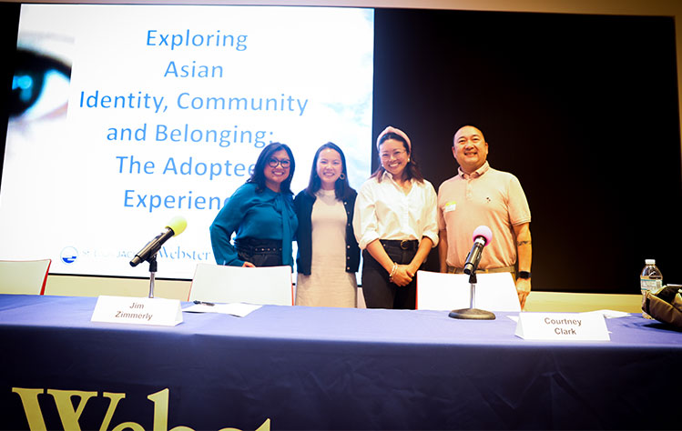 Event panelists (and moderator Michelle Li) pose for a photo onstage after the event.