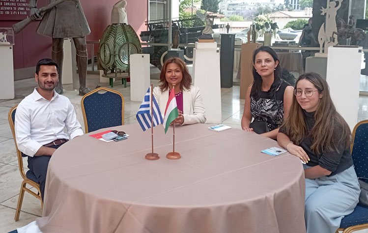 Webster Athens students seated at a table during an embassy reception.