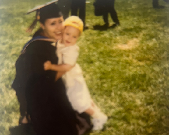 Rachel Burns and her son share a moment following Rachel's graduation from Webster in 2020