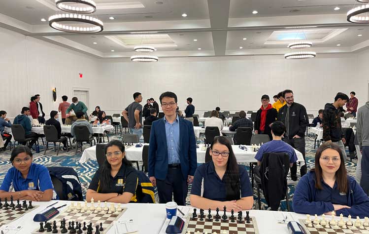 Coach Liem Le with the Webster students who were named the best college female chess players in the United States at the tournament