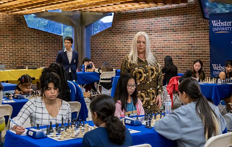 Webster University Coach Liem Le and retired Webster University Coach Susan Polgar carefully watch the competitors during the 20th annual Susan Polgar Foundations Girl's Invitational Chess Tournament
