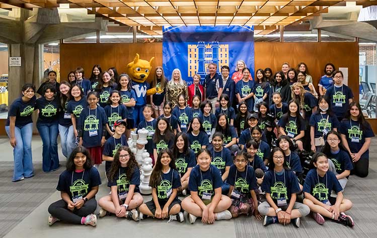 Susan Polgar, Chancellor Elizabeth (Beth) J. Stroble, President Julian Z. Schuster, Chess Coach Liem Le and Webster Groves Mayor Laura Arnold pose with support staff and the competitors at the 20th annual All-Girl's Chess Tournament.