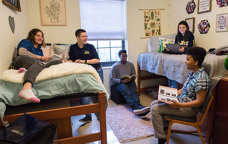 A group of Webster students hanging out in a dorm.