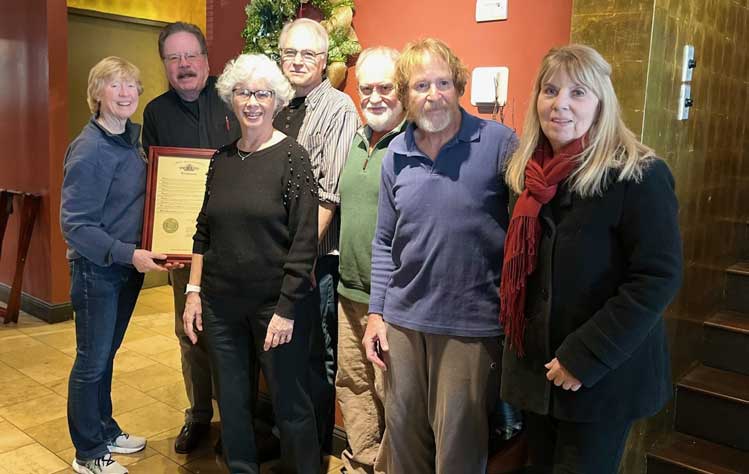 State Rep. Deb Lavender presents Don Corrigan with a recognition, along with his colleagues from Webster University