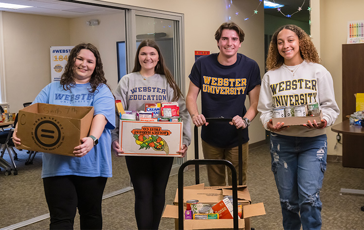 Members of the Student Education Association organizing supplies from a canned food drive