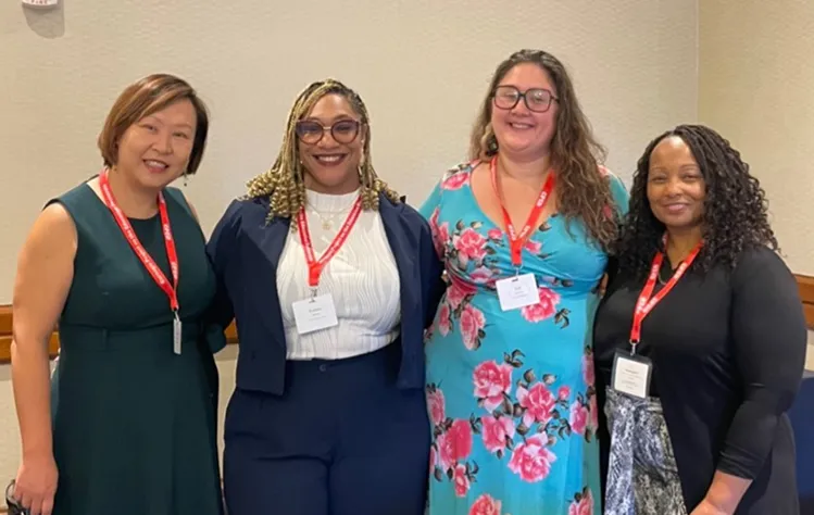 Lee-Johnson and three Webster University doctoral students pose for a photo at the CPED Convening.