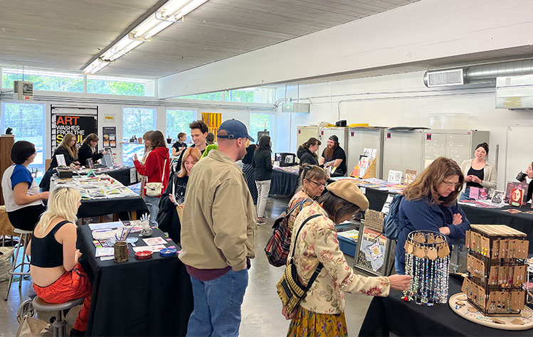 Attendees browse booths inside the Visual Arts Studio at the recent DADAH Market.