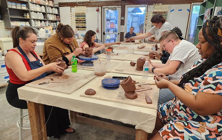 Participants crafting items in the ceramics workshop.