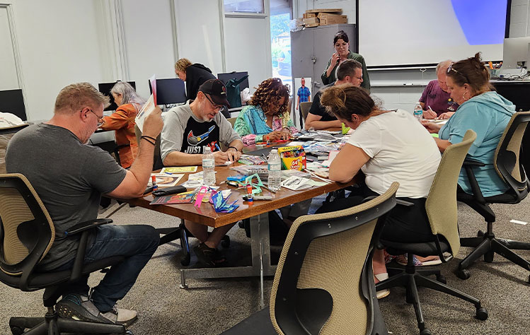 Participants gathered around table for an illustration session.