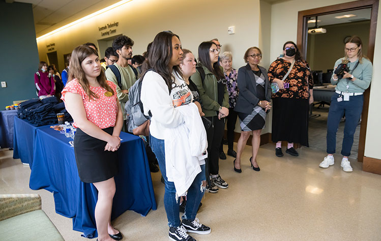 Event attendees line the hall. 