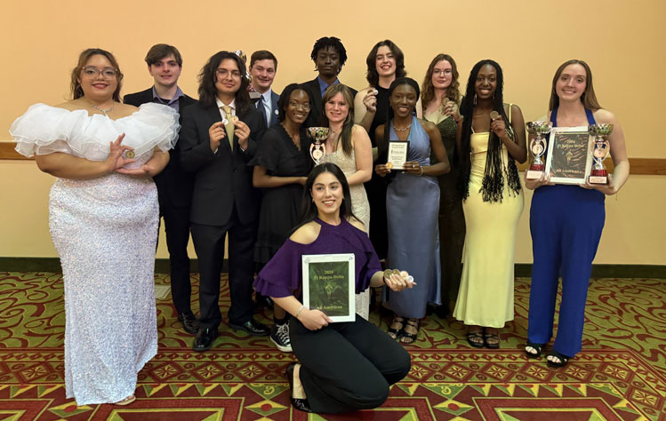The Webster University Forensic and Debate Team with their awards