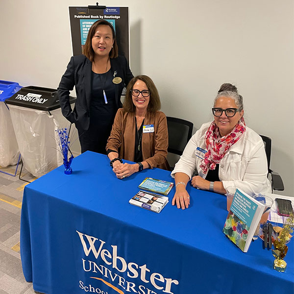 Lee-Johnson, Fyfe, and Reyes at the School of Education EXPO.