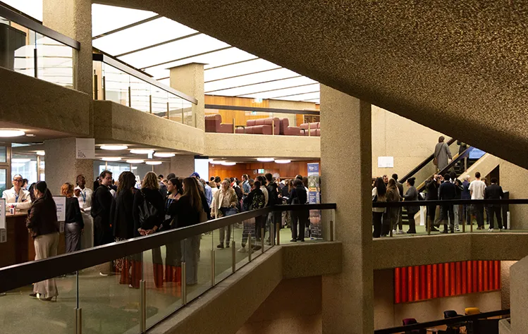 Conference attendees wait in line on the second floor to register at the Geneva International Conference Center.