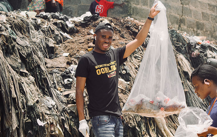 A Webster student cleans plastic from an Accra beach