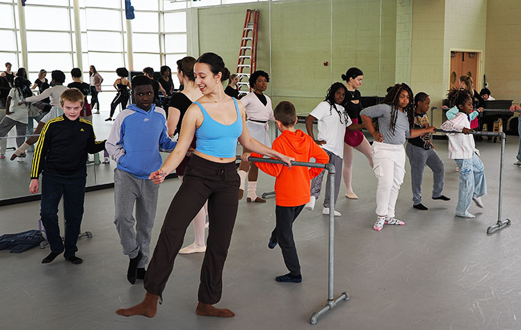 Fourth Graders from Givens Elementary practice ballet alongside Webster students.