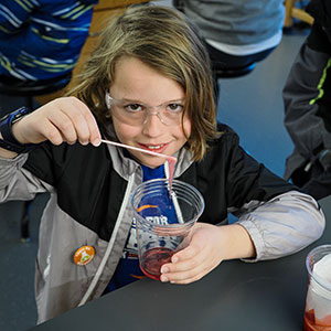A Givens Elementary student shows off strands of DNA extracted from a strawberry.