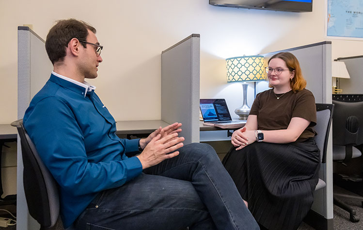 Professor Dani Belo and history student Samantha Ramay discuss her research project in the Global Policy Horizon Lab on the Webster Groves campus.