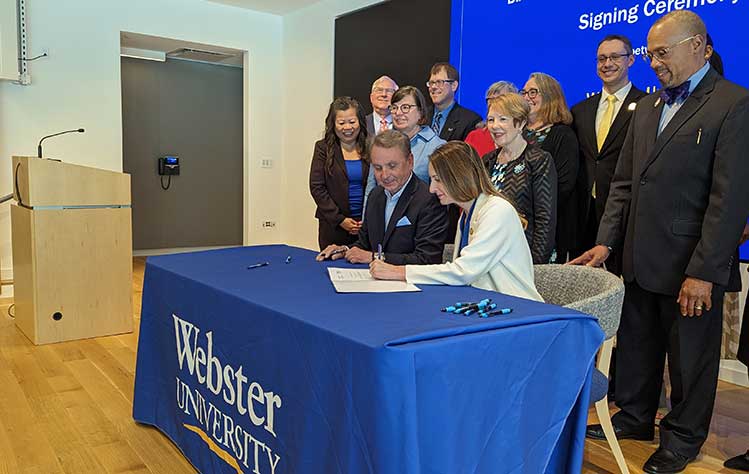 Webster and Goldfarb officials sign an agreement allowing students to earn dual biology and nursing degrees.