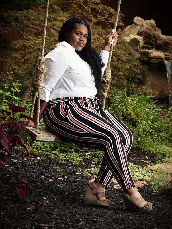 Photo of Jaleesa Smith on a swing.