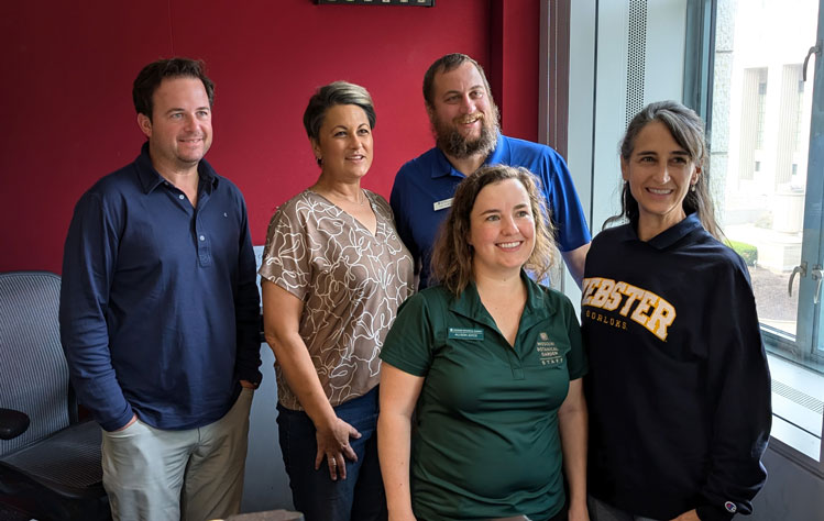 Professor Kennerly-Brown poses with research colleagues and KMOX hosts