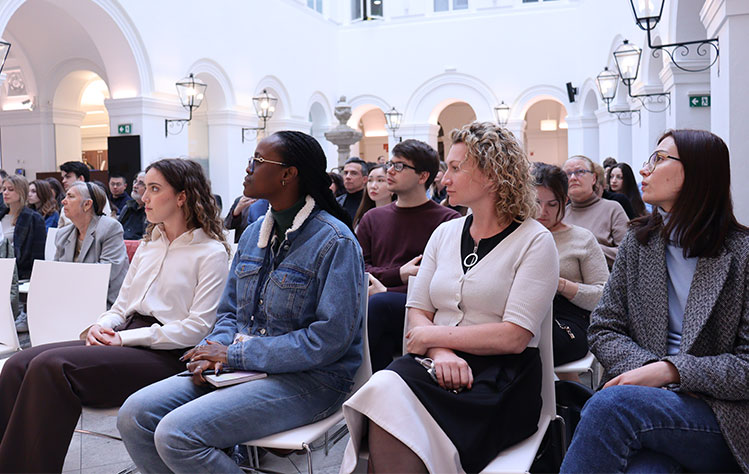 Members of the Vienna community sit in the atrium of the Palais Wenkheim for Leonard's public lecture.