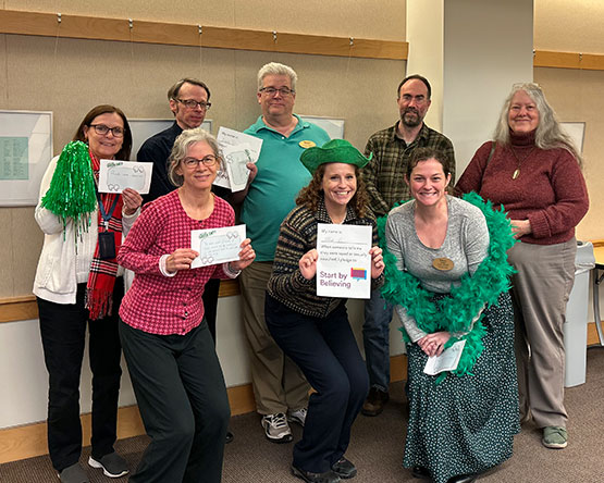 Staff from The Webster University Library pose with their Green Dot and Start By Believing pledges.