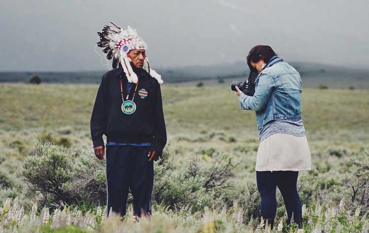 Matika Wilbur is photographed while taking a photograph