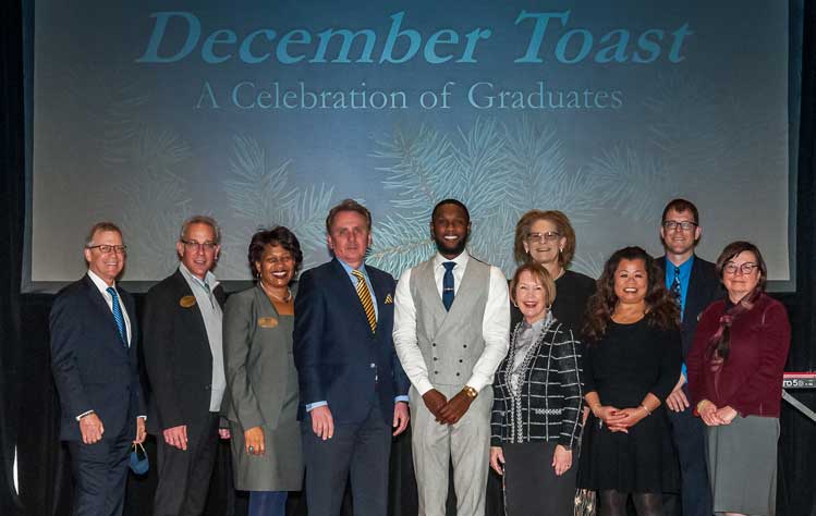 Chancellor Stroble and Neal Richardson pose with President Schuster, deans and Academic Affairs staff during the annual 2021 December Toast. Chancellor Stroble and Neal Richardson pose with President Schuster, deans and Academic Affairs staff during the annual 2021 December Toast.