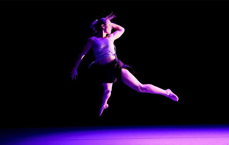 Photo of a Webster University BFA dancer leaping during a performance.