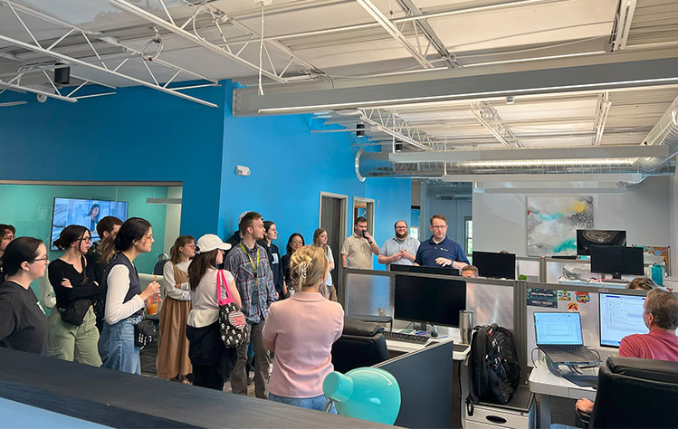 Webster University graphic design students explore Notion’s office during a summer studio tour.