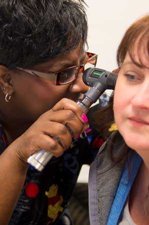 A graduate nursing student learns how to take health assessments.