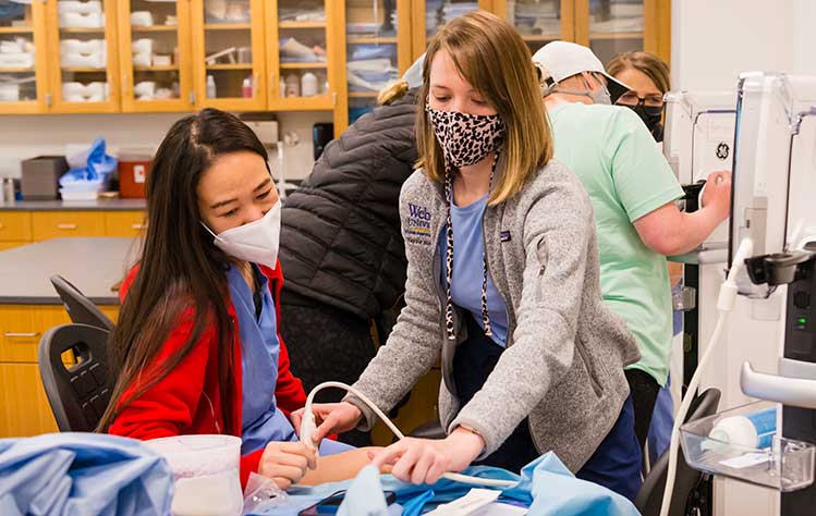Nursing students learn how to use advanced equipment