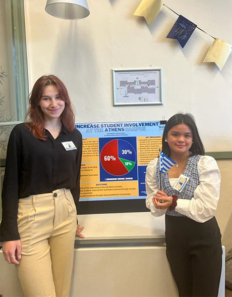 Palope and Mujezin stand next to their project presentation at the Global Student Leadership Summit.