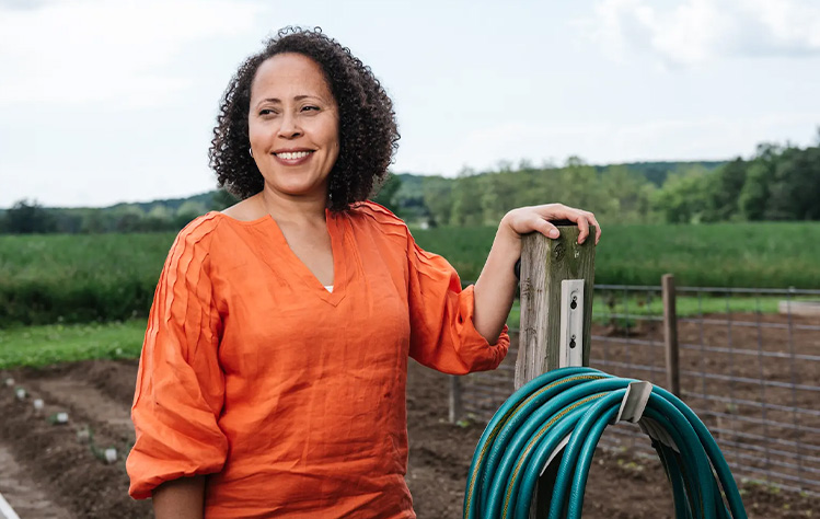 Rachel Burns poses for a photo on her farm