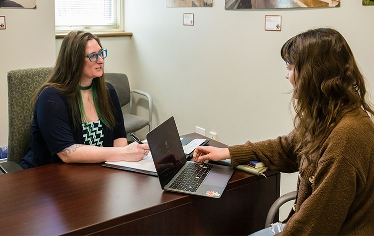 An academic counselor with a student.