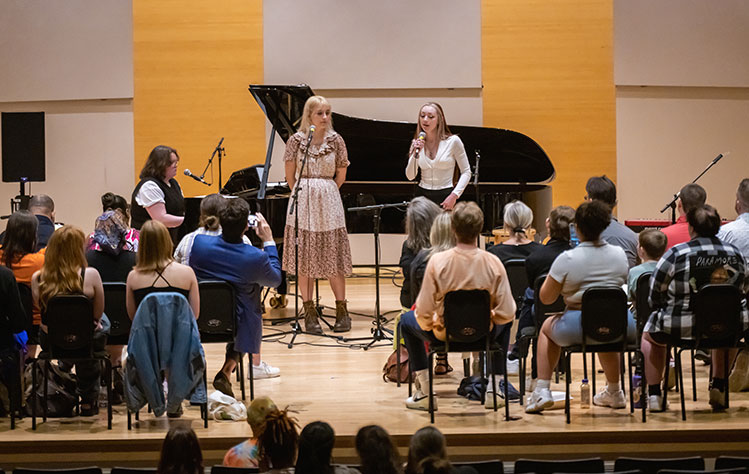 Two students perform during a songwriting masterclass event at Webster University. 