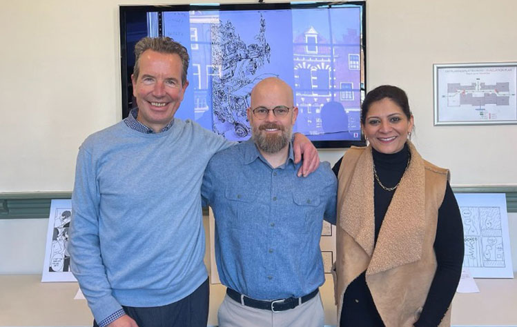 Ben Sawyer stands with Jean Paul van Marissing and Sheetal Shah at an art show in Leiden.