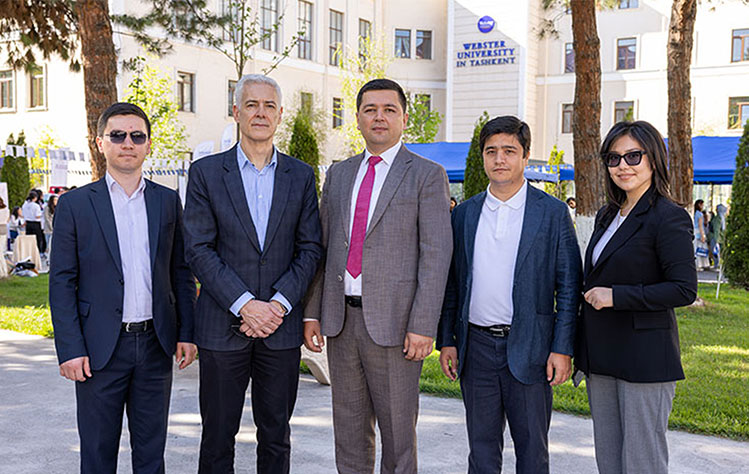 Five Webster University in Tashkent officials pose for a photo at the 2024 career fair.