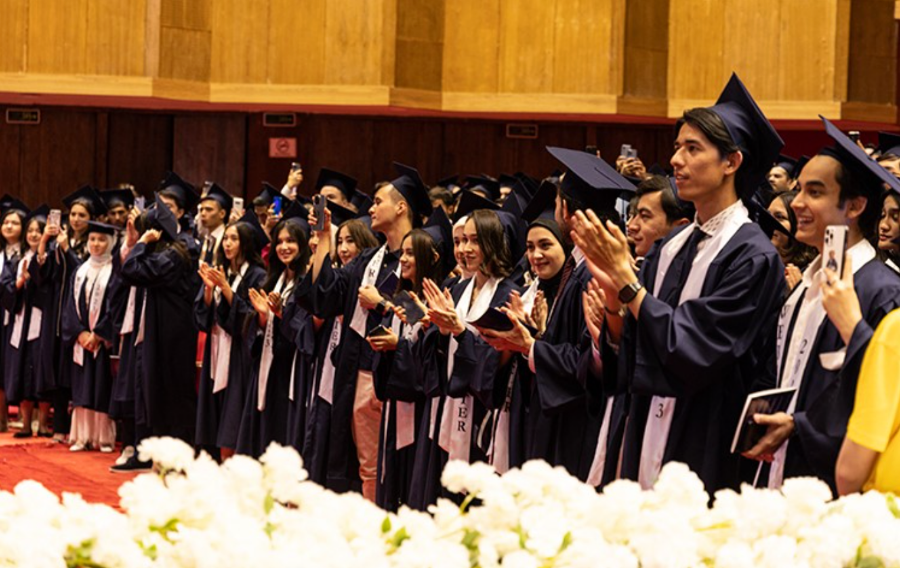 The new Webster University alumni applaud.