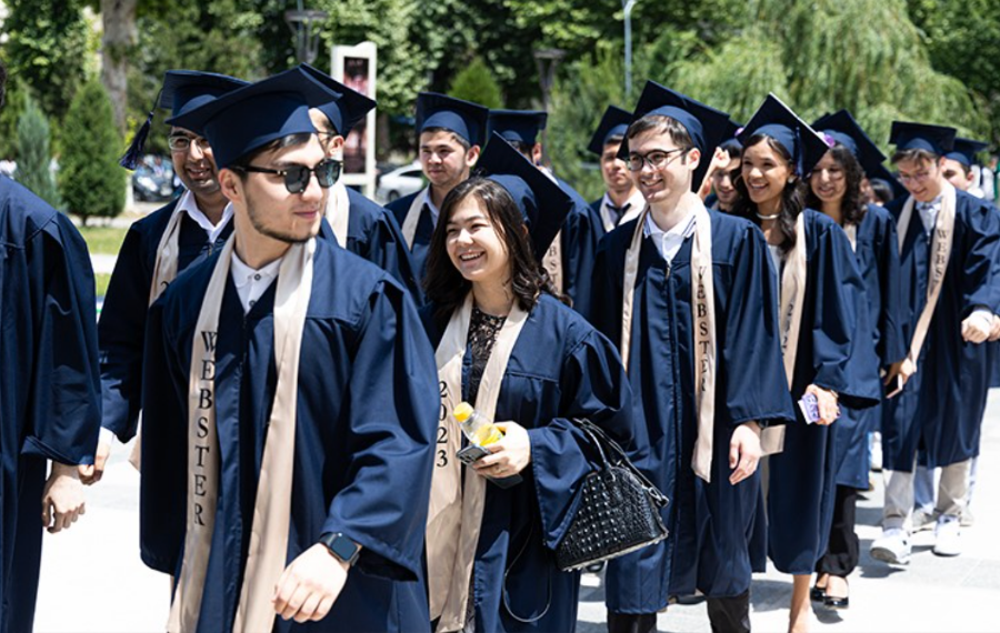 Webster University Tashkent graduates smile as they prepare to enter their Commencement ceremony. 