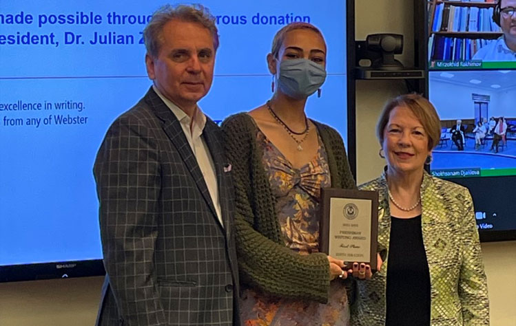 Edith Zerazion of the Webster Groves campus, the 2021-2022 Freshman Writing Award first place winner, receives her award from Dr. Julian Schuster, President, and Dr. Elizabeth (Beth) J. Stroble, Chancellor.