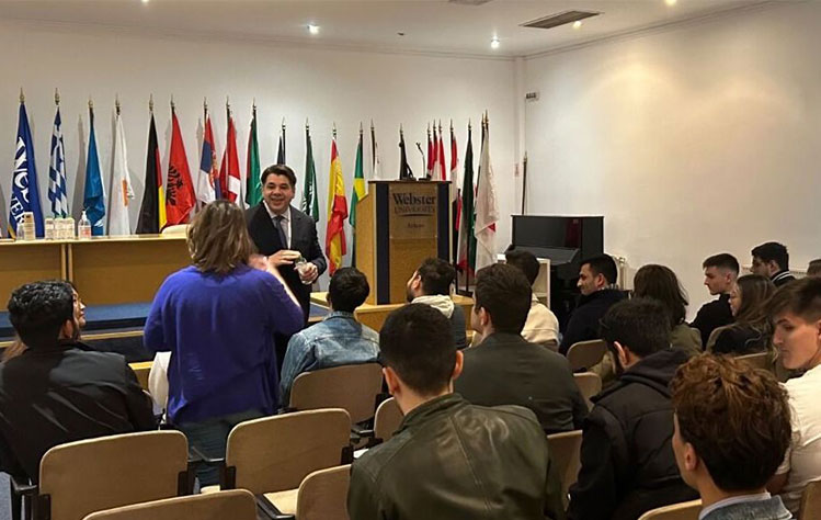 George J. Tsunis speaks with Webster University Athens International Relations students as part of the forum’s opening address.
